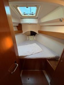 a small bed in the back of a boat at Dorfe Kotor Muo in Tivat