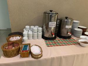 a table with a table cloth with baskets and a coffee maker at Hotel Los Condores in Uspallata +26 photos