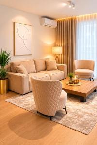 a living room with a couch and a table and chairs at Beograd na vodi-Belgrade Waterfront in Belgrade