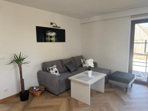 a living room with a couch and a table at Wczasowa 26 in Karwieńskie Błoto Drugie