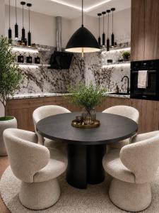 a dining room with a black table and chairs at Beograd na vodi-Belgrade Waterfront in Belgrade +63 photos