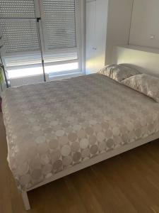 a large bed in a room with a window at Bingo CC Tuzla in Železnička Stanica Tuzla