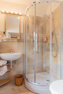 a bathroom with a shower and a sink at Arndt's Bootshaus in St. Wolfgang +86 photos