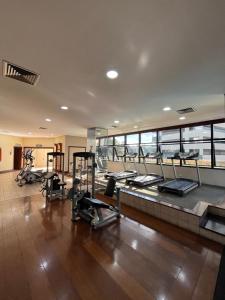a gym with several treadms and machines in a building at Summit Flat São José dos Campos in São José dos Campos