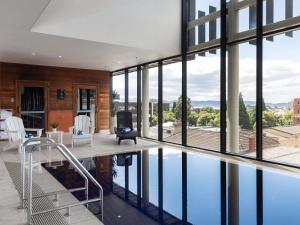 a house with a swimming pool and a living room at Ibis Styles Hobart in Hobart