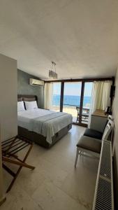 a bedroom with a bed and a view of the ocean at Terrace Urla in Urla +13 photos