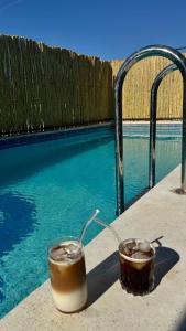 two candles on a table next to a swimming pool at Terrace Urla in Urla