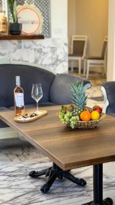 a table with a bowl of fruit and a bottle of wine at Terrace Urla in Urla