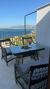 a table on a balcony with a view of the ocean at Terrace Urla in Urla