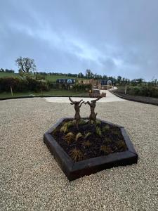 a statue of a tree in the middle of a road at The Hare's Lair in Monaghan