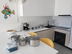 a kitchen with pots and pans on a table at Sea Star in Žman