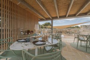 a dining room with a table and chairs at Setteminne Resort Design in Favignana