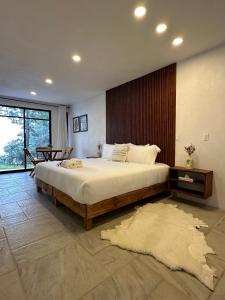 a bedroom with a large bed and a table at Casa Madera Completa in Zacatlán