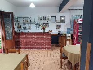 a restaurant with a table and chairs and a bar at Altin Prendi B&B in Divjakë
