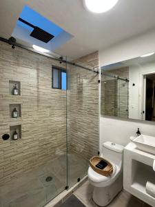 a bathroom with a shower and a toilet and a sink at Casa Madera Completa in Zacatlán +34 photos