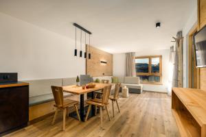 a kitchen and dining room with a table and chairs at Neuhuberhof in Vols am Schlern