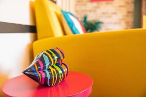 a colorful shoe sitting on top of a red table at Unique By Monique Kingsholm Bungalow Parking in Gloucester +15 photos