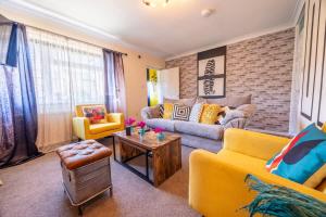 a living room with a couch and a table at Unique By Monique Kingsholm Bungalow Parking in Gloucester