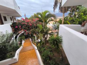 a stairway with flowers and plants on a balcony at Apartment Parque Royal Costa Adeje in Adeje
