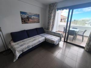 a living room with a couch and a balcony at Apartment Parque Royal Costa Adeje in Adeje +42 photos