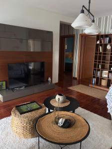 a living room with two tables and a fireplace at Luxury Waterfront Apartment in Boka Bay, Stollywood in Donji Stoliv