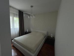 a bedroom with a bed and a window at Luxury Waterfront Apartment in Boka Bay, Stollywood in Donji Stoliv