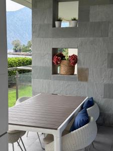 a table and chairs in a room with a fireplace at Luxury Waterfront Apartment in Boka Bay, Stollywood in Donji Stoliv +11 photos
