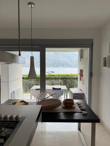 a kitchen with a table and a view of the ocean at Luxury Waterfront Apartment in Boka Bay, Stollywood in Donji Stoliv