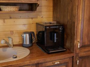 a coffee maker on a counter in a kitchen at Domek Hortensja in Zawady