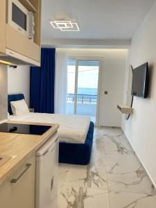 a hotel room with a bed and a television at House Katerina Mediterranean in Sarti