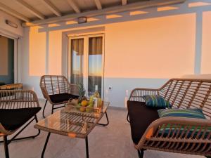 a living room with chairs and a table at Amelie apartments in Naxos Chora