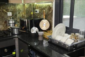 a kitchen with a counter top with a sink at Belgaid résidence OREVA in Oran +2 photos
