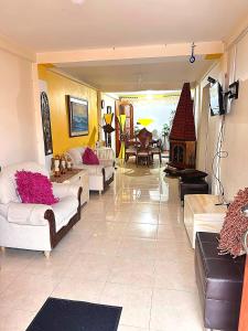 a large living room with couches and a fireplace at Quimbaya Private House in Quimbaya