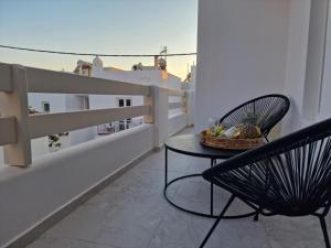 a balcony with a table and a basket of fruit at Amelie apartments in Naxos Chora