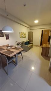 a living room with a table and a couch at Flat Aconchegante - Park Veredas 417 in Rio Quente +56 photos