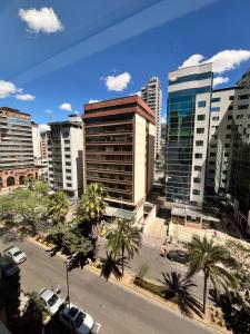 a city skyline with tall buildings and palm trees at BlueZone Apartments in Quito