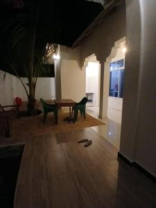 a room with a table and two chairs and a cat at Sun House Kendwa in Kendwa