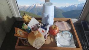 a tray of food on a table in front of a window at Hotel Styllus in São Paulo