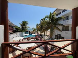 a balcony with a view of a resort with a pool at Hotel Las Terrazas de Bonanza in Zorritos