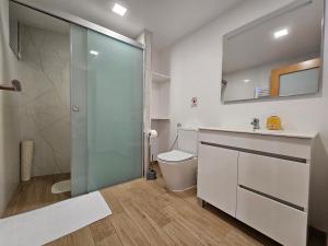 a bathroom with a shower and a sink and a toilet at Celeiro do Avô in Santana +50 photos