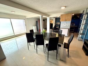 a dining room table and chairs in a kitchen at R&A Hostal in Mexico City +19 photos