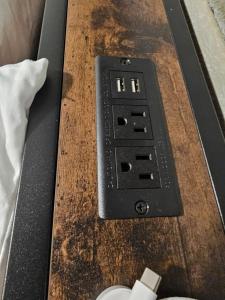 a remote control sitting on top of a wooden table at Earl Street Retreat Unit A in Stanfield