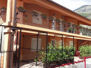a building with a balcony with plants on it at Apartments Sergej in Sutomore
