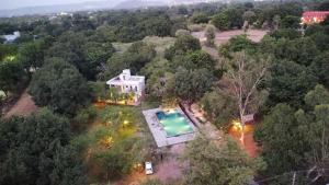 an overhead view of a house with a swimming pool at The chocolate frog in Thūr +26 photos