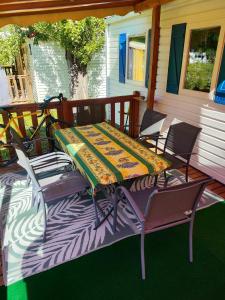 a table on a porch with two chairs and a bike at MOBIL-HOME n 95 in Barrême