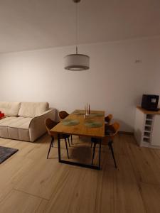 a living room with a table and a couch at Casa David in Băile Govora