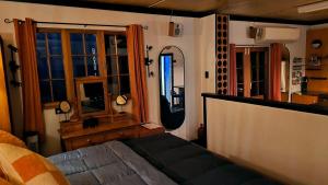 a bedroom with a bed in a room with windows at Algo Azul Something Blue in Wellington