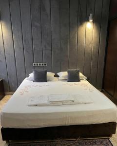 a large bed with white sheets and pillows on it at SINGAPOUR MAROC in Casablanca