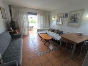 a living room with a couch and a table at Apartment Parque Royal Costa Adeje in Adeje