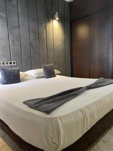 a large white bed with blue pillows on it at SINGAPOUR MAROC in Casablanca +7 photos